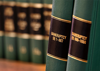Two legal books on bookshelf reading bankruptcy